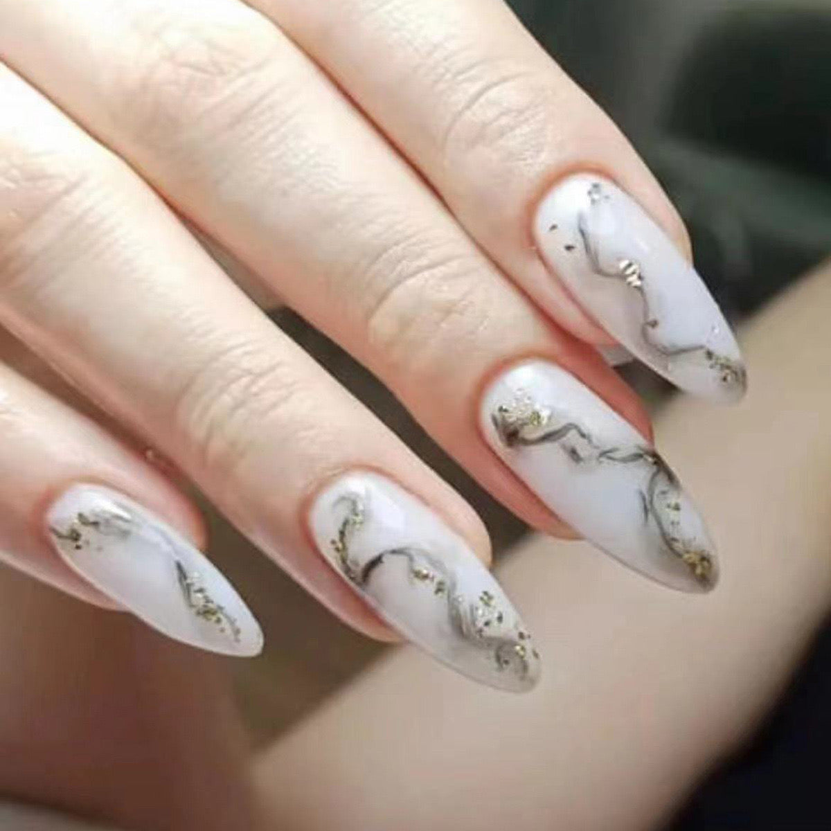 Elegant Gold Marble Nails with Shine
