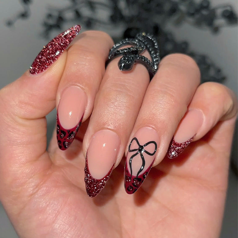 Glamorous Enchantment Long Almond Red Glitter Press On Nail Set with Intricate Black Bow Design