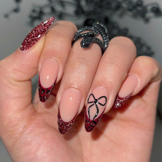 Glamorous Enchantment Long Almond Red Glitter Press On Nail Set with Intricate Black Bow Design
