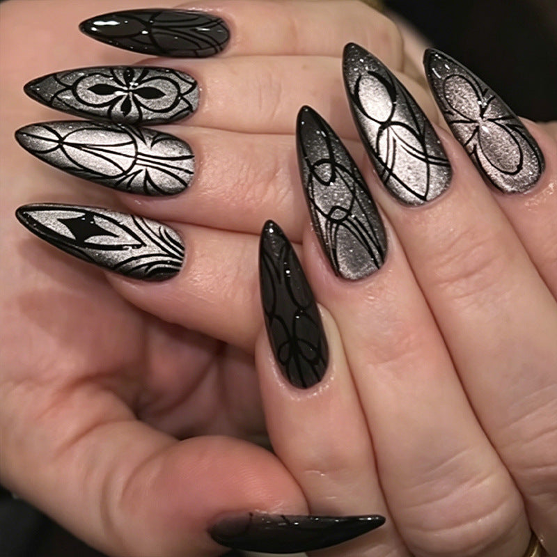 Enchanting Black Stiletto Long Nails with Intricate Metallic Designs