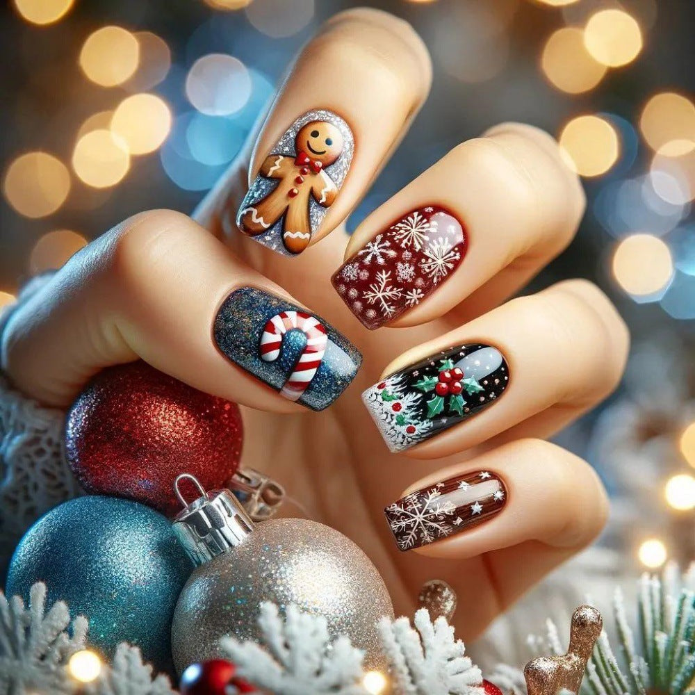 A set of press-on nails featuring a festive design with red glittery snowflakes, a gingerbread man, and Christmas-themed decorations.