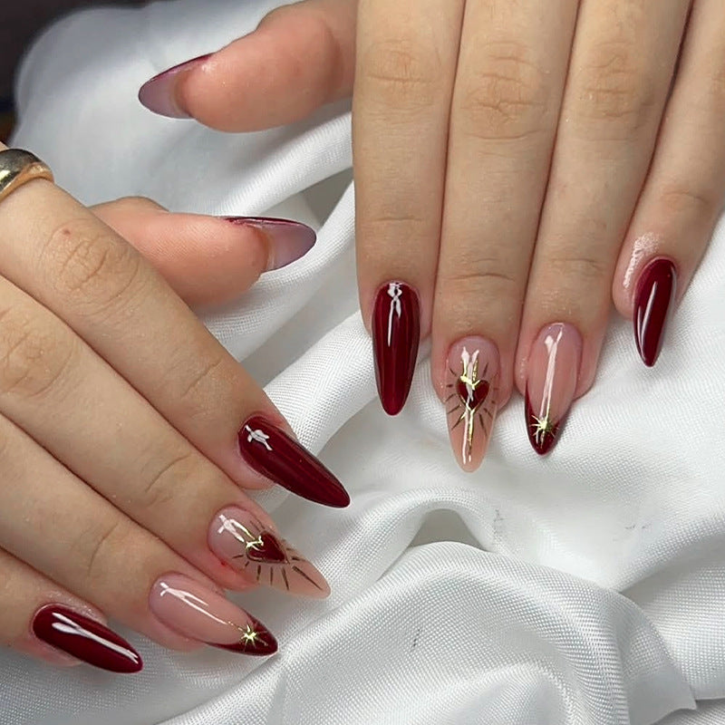 Glamorous Fashion Statement Long Almond Burgundy Nails with Striking Gold Accents