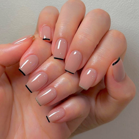 Elegant Chic Long Coffin Neutral Nails with Stylish Black Tips and Dazzling Glitter Detail