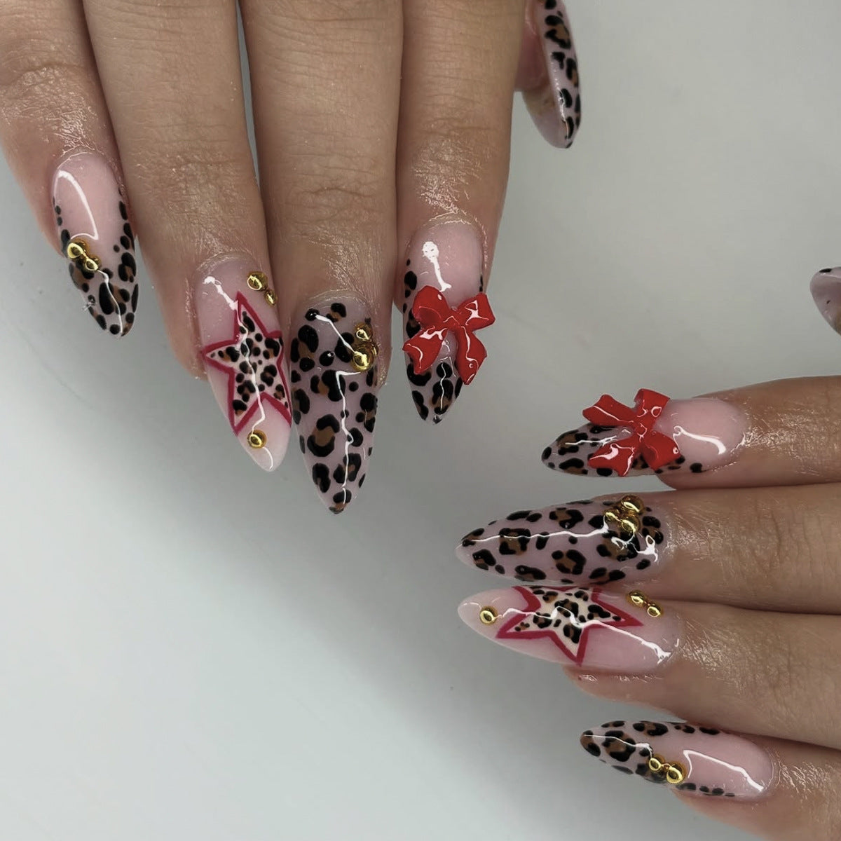 Wild Elegance Long Stiletto Leopard Print Press on Nails with Bold Red Bows and Star Accents