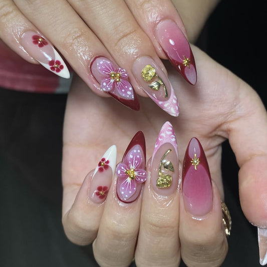 Floral Fantasy Long Almond Burgundy Gradient Press-On Nail Set with Elegant Gold Accents and Unique Floral Designs