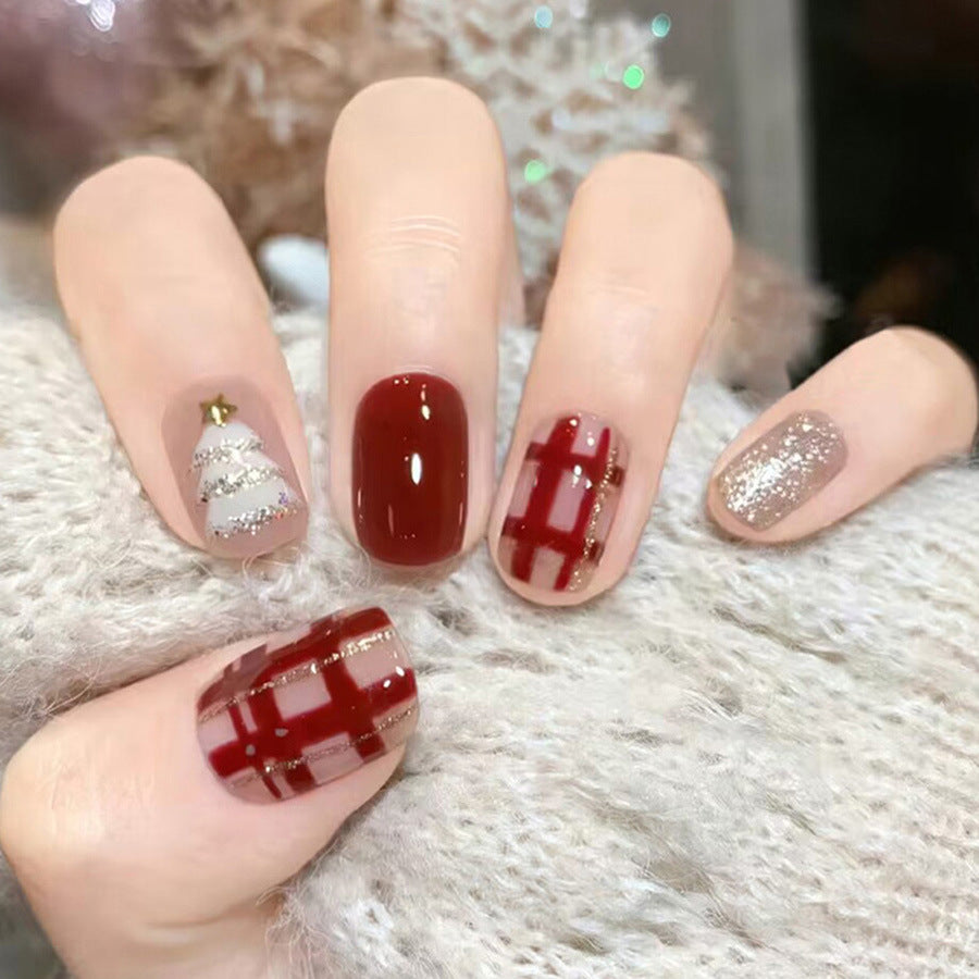 Festive Winter Wonderland Short Soft Oval Burgundy and Shimmering Gold Press On Nail Set with Holiday Themed Designs