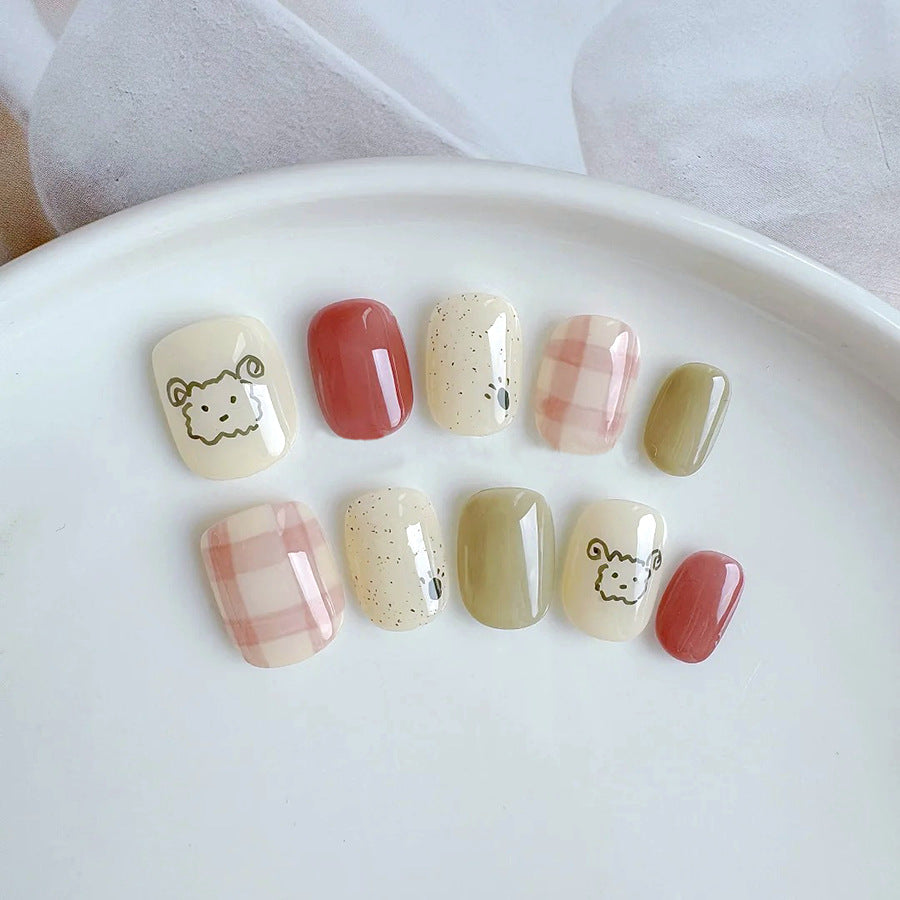 Whimsical Meadow Short Squoval Press On Nail Set in Pastel Yellow Green and Earthy Red with Adorable Animal Illustrations