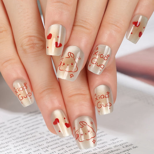 Whimsical Love-Themed Beige Coffin Medium Length Press On Nail Set with Red Accents and Adorable Bunny Illustrations