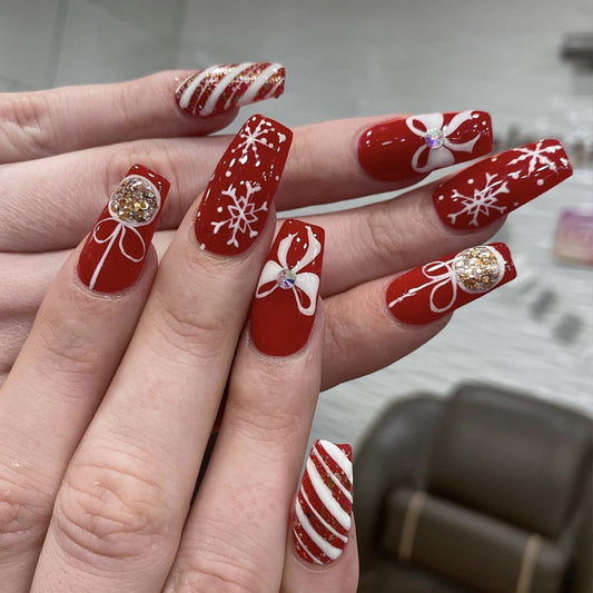 Festive Cheer Medium Square Red Nails with Glittering Snowflakes and Bow Accents