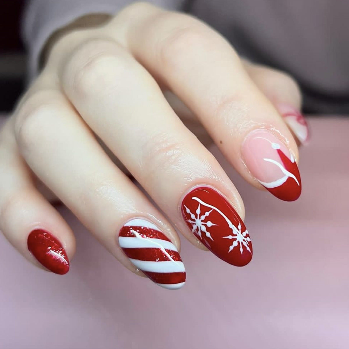 Festive Charm Medium Almond Red and Pink Nail Set with Snowflake and Candy Stripe Designs
