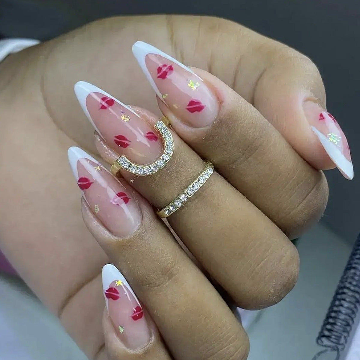 Romantic Kiss Inspired Long Almond Shaped Clear and White Nails with Red Lipstick Patterns and Gold Glitter Accents