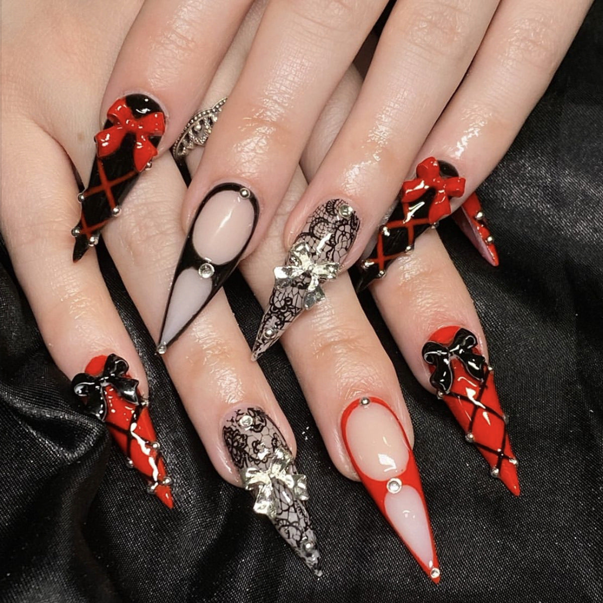Whimsical Gothic Long Stiletto Press On Nail Set in Red and Black with Intricate Bow and Lace Design
