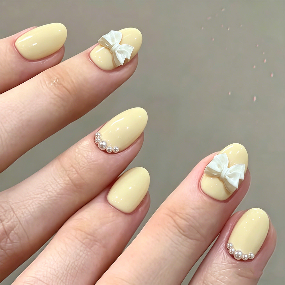 Charming Bow Accent Short Oval Yellow Press on Nail Set