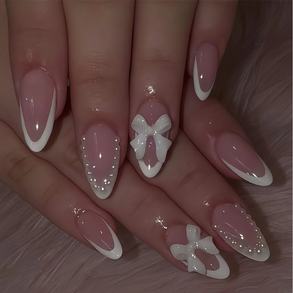 Whimsical Elegance Medium Almond Pink Press On Nail Set with Stylish White Tips and Chic Bow Embellishments