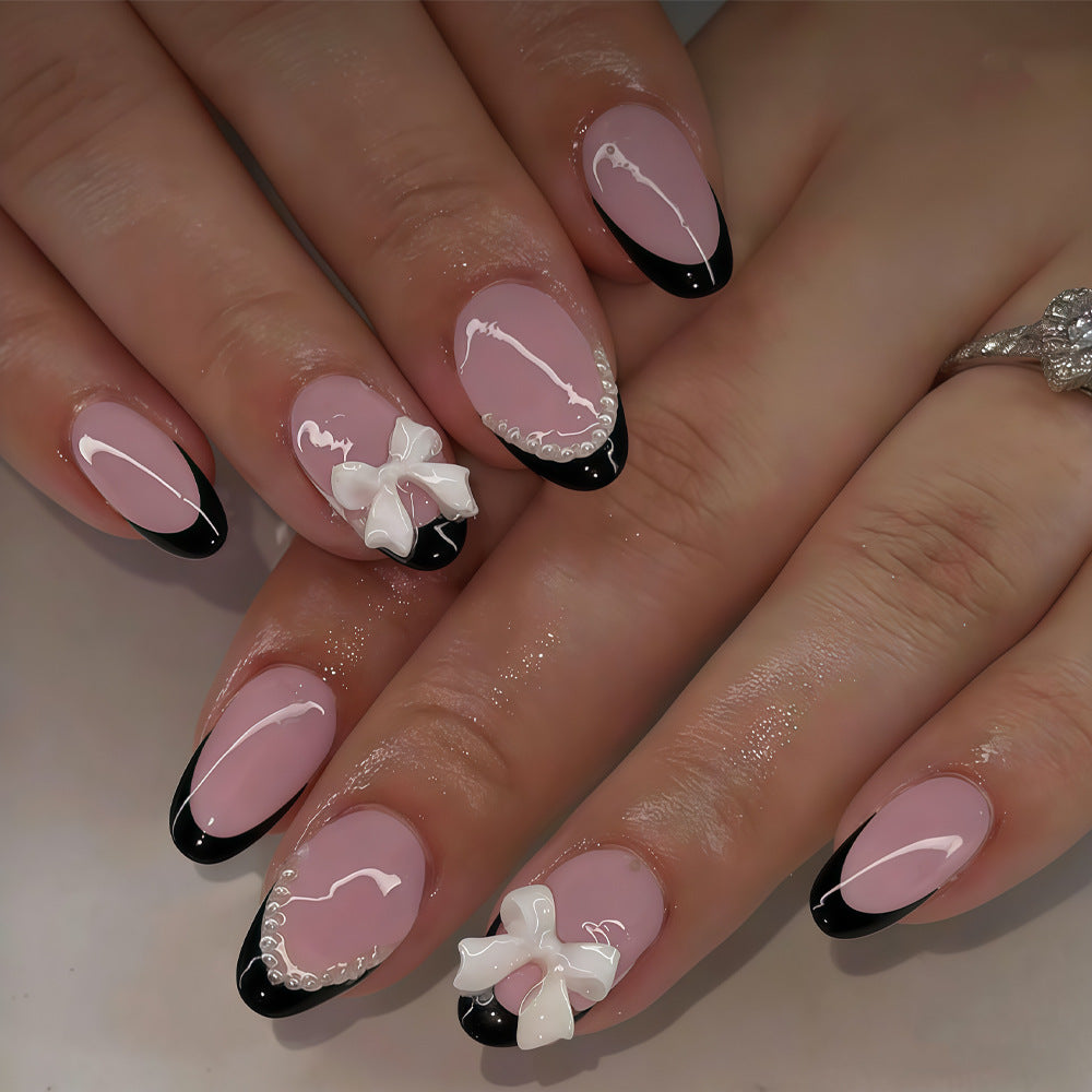 Chic Elegance Short Almond Pink with Black Tips and Charming Bow Accents Press On Nail Set