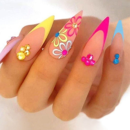 Colorful nail art with flowers and decorations on a white background