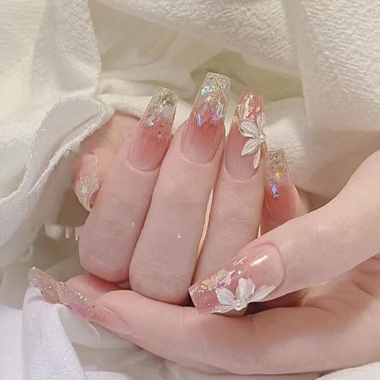 Whimsical Blossom Long Coffin Beige Pink Nails with Iridescent Glitter and Floral Accents