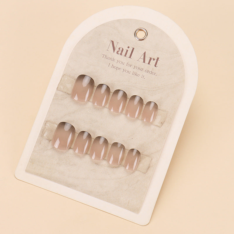 A set of beige press-on nails presented in a cardboard package with the brand name 'The Nail Art' and a hopeful message 'Hope you like it.'.