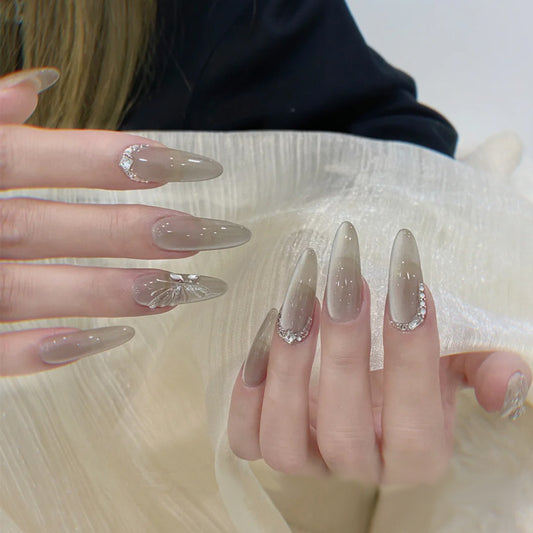 Whimsical Elegance Long Almond Ombre Beige Nails with Butterfly and Crystal Accents