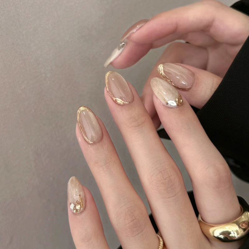 Glamorous Elegance Medium Oval Beige Press On Nail Set with Gold Accents and Rhinestone Detail
