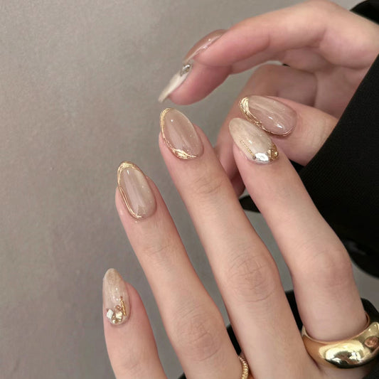 Glamorous Elegance Medium Oval Beige Press On Nail Set with Gold Accents and Rhinestone Detail