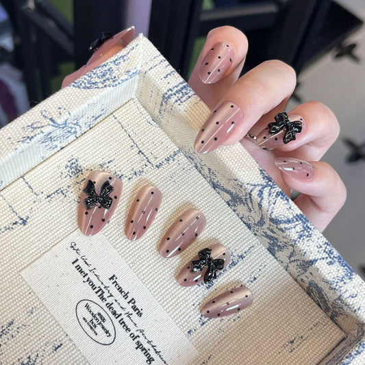 Elegant Parisian Charm Medium Almond Beige with Black Dots and Bow Accents Press-On Nail Set