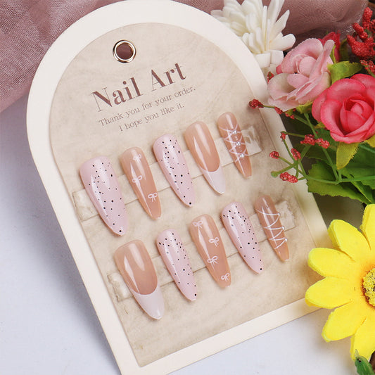 Charming Elegance Long Almond Pink Nails with Dainty Bow Accents and Polka Dot Design