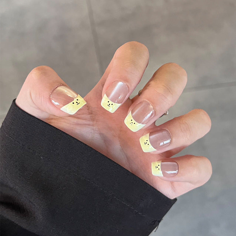 Sunny Delight Short Square Press-On Nails with Cheerful Yellow Tips and Cute Character Design