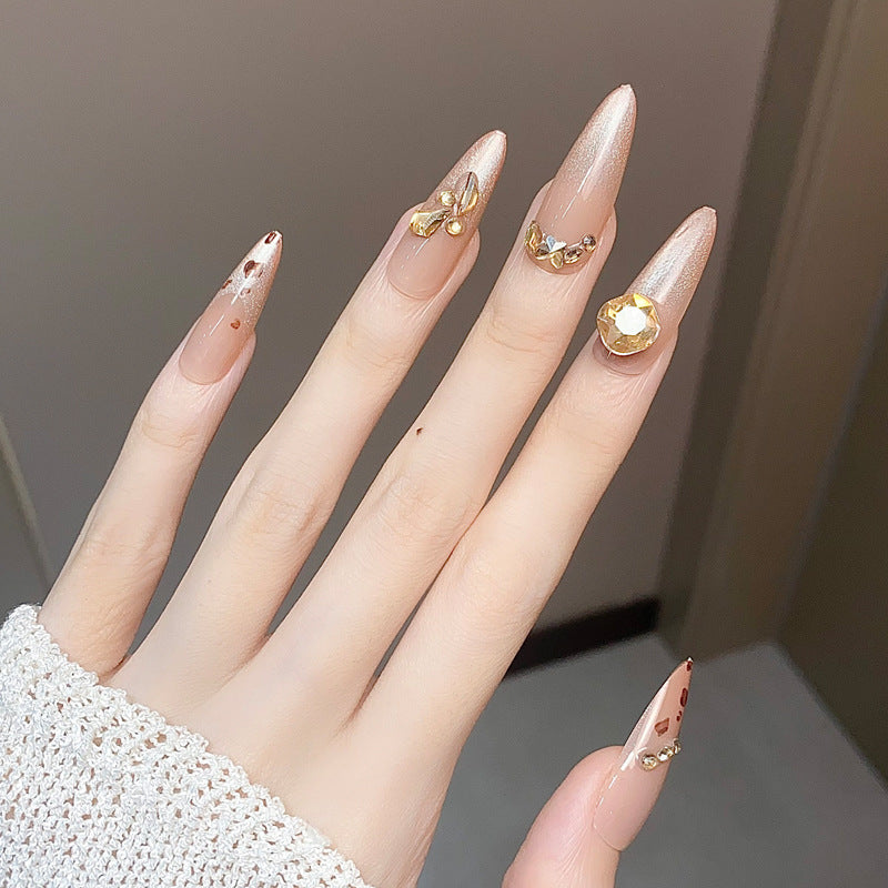 Glamorous Elegance Long Almond Beige Nails with Gold Accents and Unique Embellishments