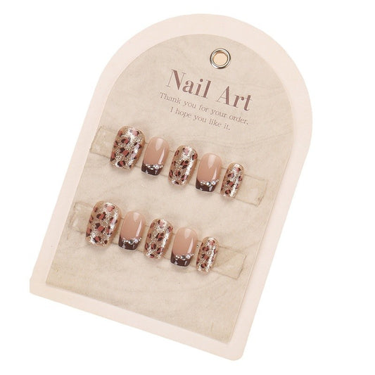 Set of nail art decorations on a beige card with 'Nail Art' text.