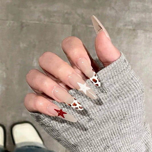 Celestial Dreams Long Almond Beige Nails with Star Accents and Unique Animal Print Design
