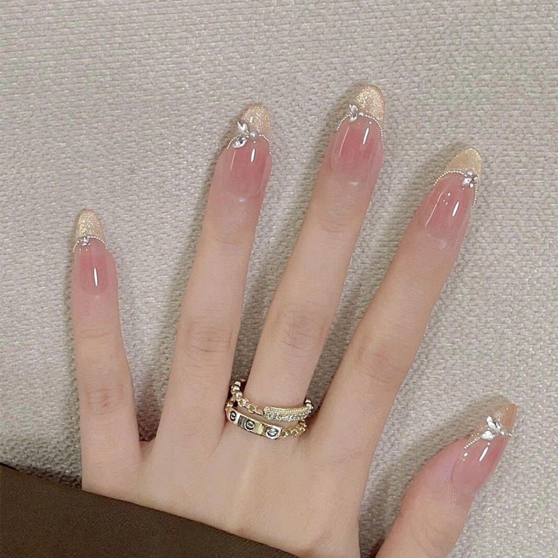 Elegant Garden Inspired Long Oval Shaped Beige with Glittery Gold Tips and Charming Floral Accents Nail Set