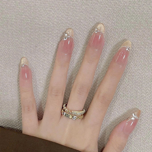 Elegant Garden Inspired Long Oval Shaped Beige with Glittery Gold Tips and Charming Floral Accents Nail Set