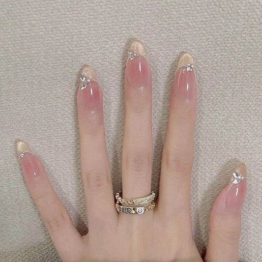 Enchanting Elegance Long Oval Beige with Gold Glitter Tips and Delicate Rhinestone Accents Nail Set