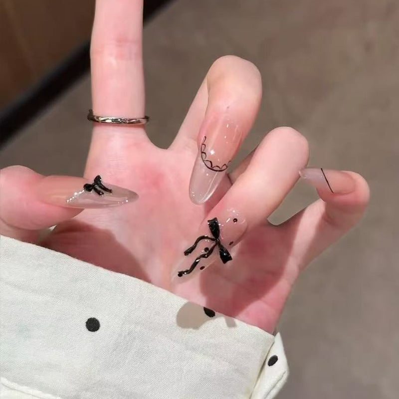 Chic Elegance Long Almond Transparent Nails with Black Bow Detail and Unique Artistry