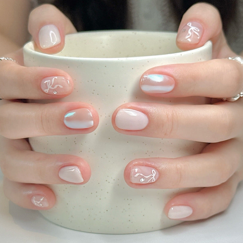 Chic Serenity Short Oval Pink Nail Set with Elegant Swirl Design