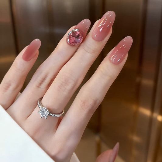 Chic Elegance Medium Almond Pink Glossy Nails with Stunning Gemstone Accent
