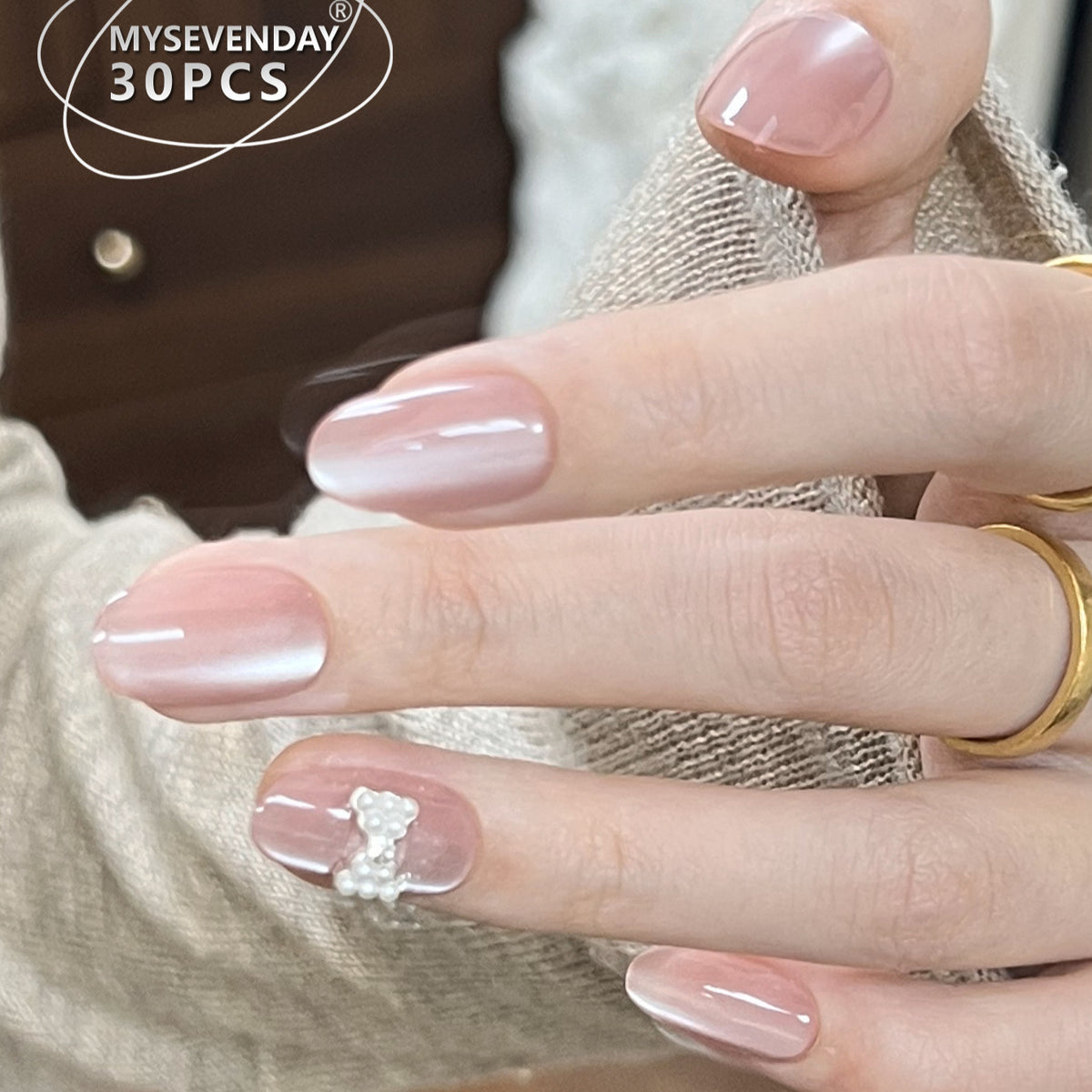Elegant Pearlescent Medium Oval Pink Nails with Charming Embellishment