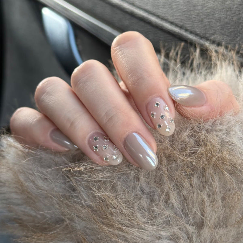 Chic Glamorous Medium Oval Shaped Beige Nails with Dazzling Rhinestone Accents