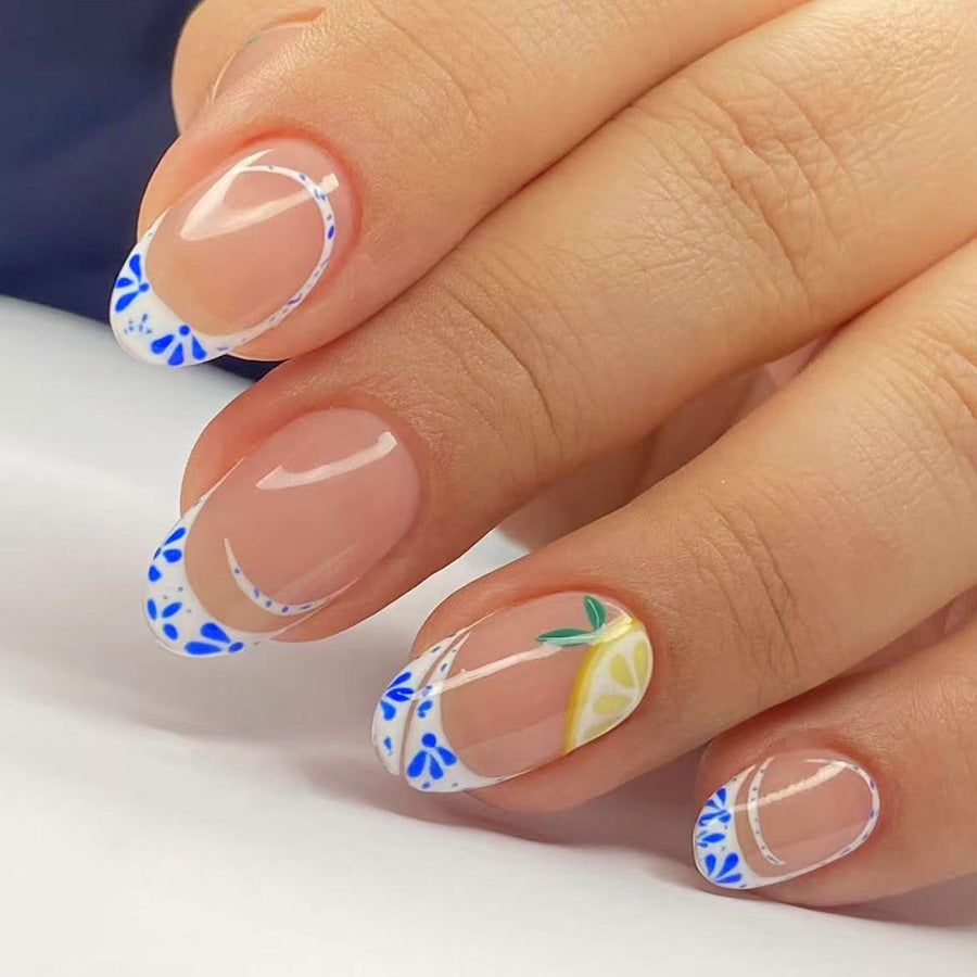 Sunny Citrus Delight Press-On Nail Set Medium Almond Shape Clear Base with Vibrant Blue Floral Accents and Fresh Lemon Design
