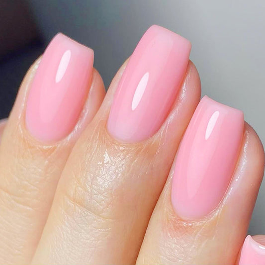 Close-up of a hand with pink nail polish on a neutral background
