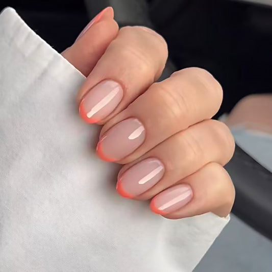 Close-up of hands with pink nail polish on a blurred background