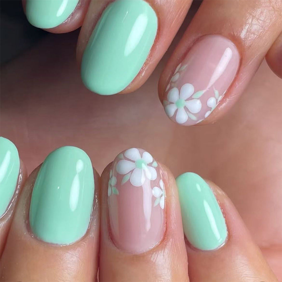 Floral Enchantment Short Oval Mint Green Press On Nail Set with Charming Daisy Designs