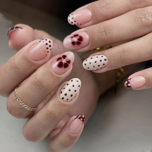 Botanical Bliss Medium Oval Soft Pink Nails with Charming Floral Accents and Dotted Designs