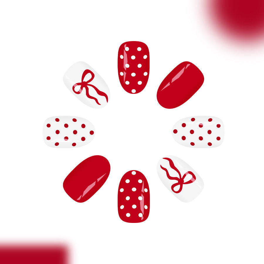 Charming Holiday Cheer Short Oval Glossy Red and White Polka Dot Nails with Bow Accents