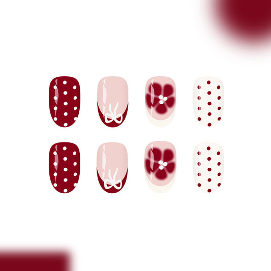 Chic Blossom Press On Nail Set Elegant Medium Oval Burgundy and White with Delicate Floral Accents and Playful Polka Dots