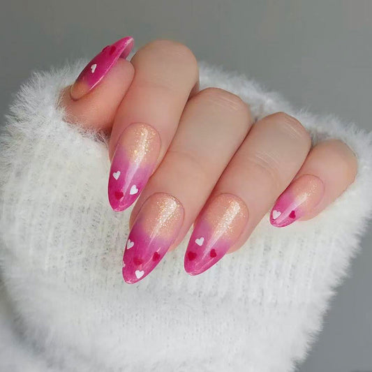 Charming Romance Long Almond Pink Ombre Nails with Heart Designs and Sparkle Finish