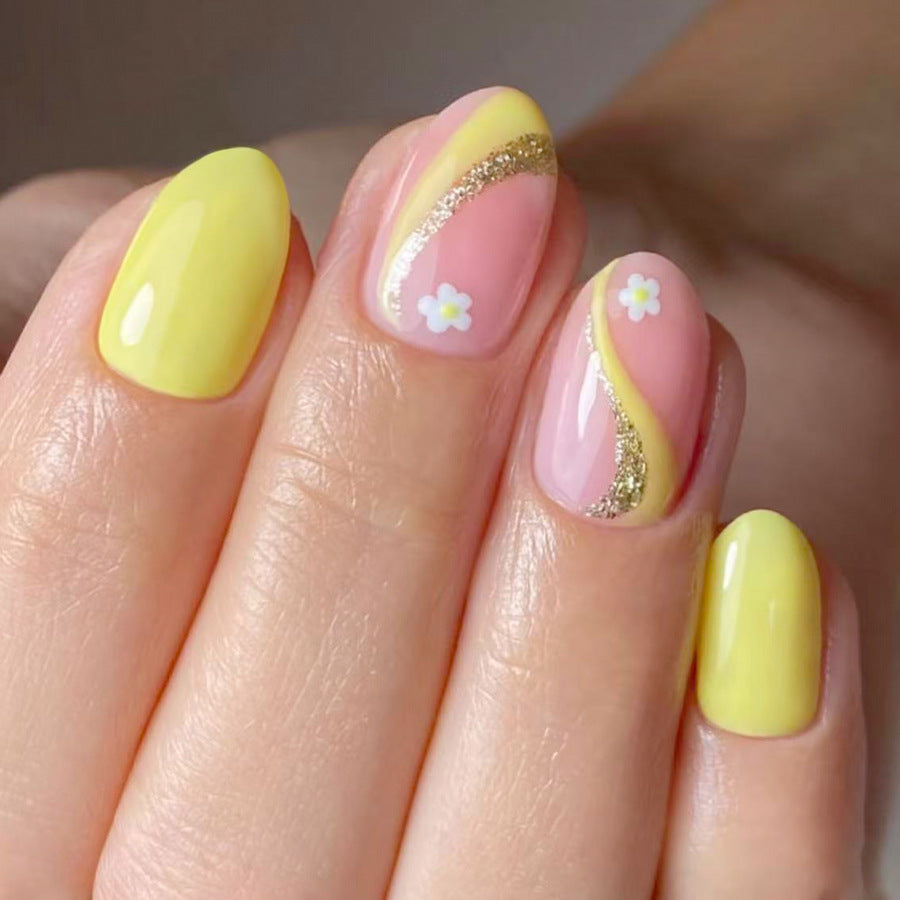 Sunny Daydream Medium Oval Yellow and Pink Press-On Nail Set with Delightful Floral Accents and Sparkling Gold Swirls