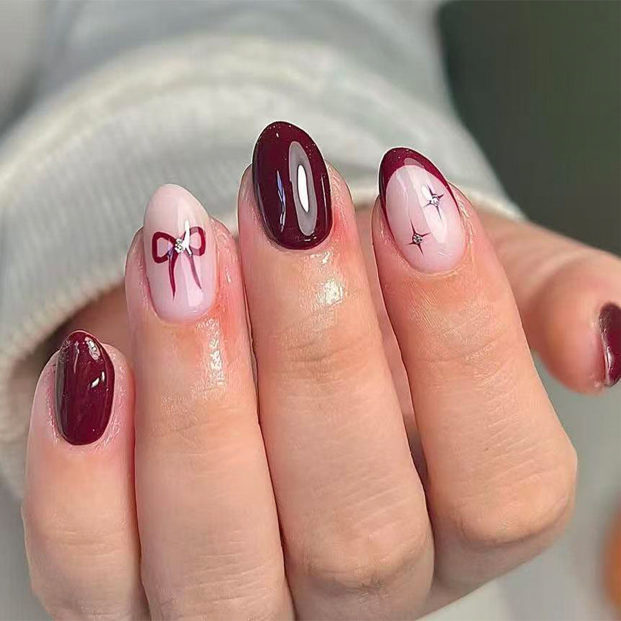 Charming Winter Collection Short Almond Burgundy Nails with Elegant Bow Detail
