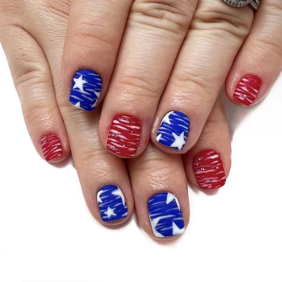 Nails with red, white, and blue designs on a white background